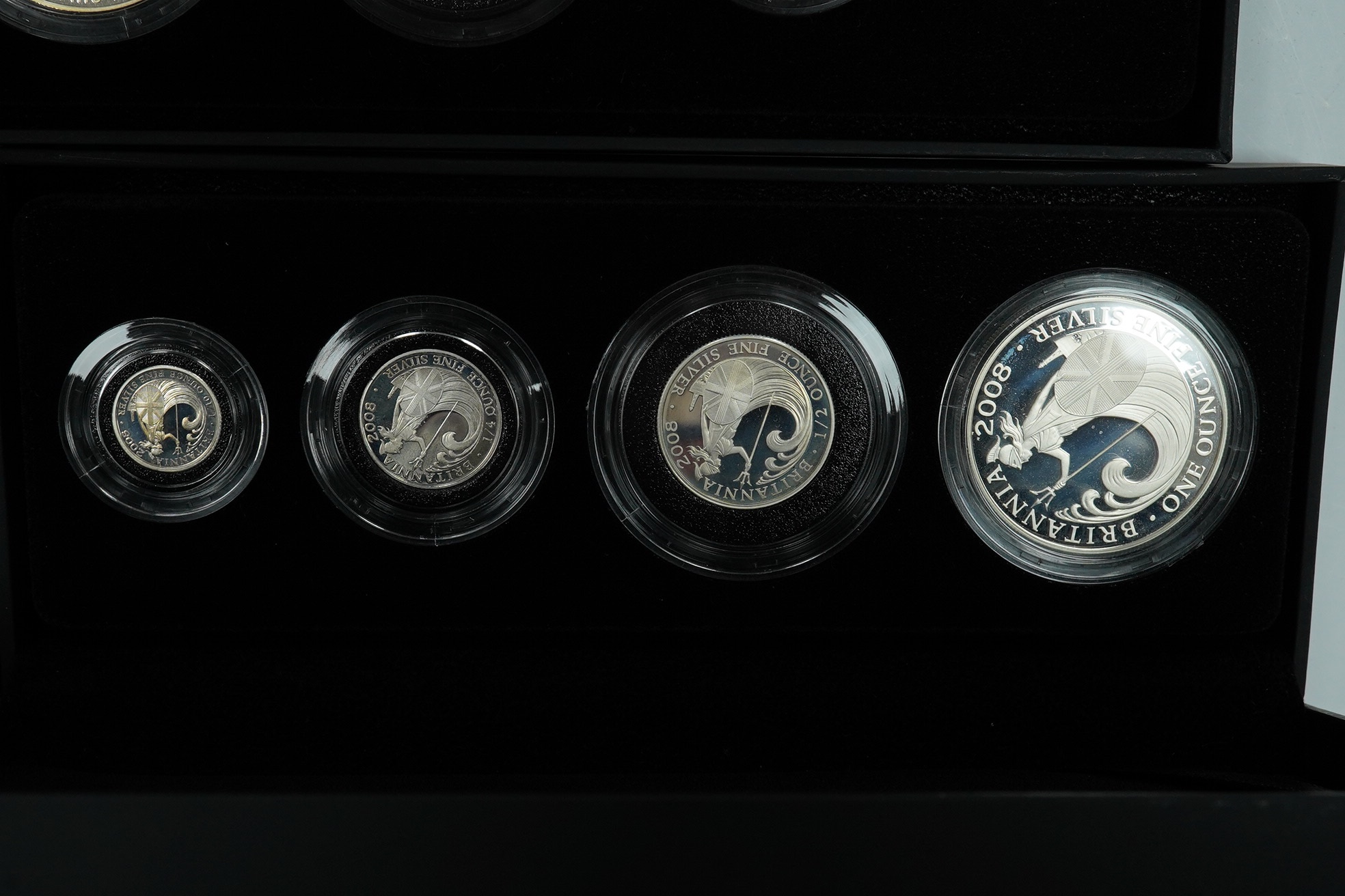 Royal Mint UK QEII proof coins, three Britannia four-coin silver proof sets, 2008, 2009 and 2011 and a Britannia collection three-coin silver proof set 2014, in 4 cases of issue with certificates